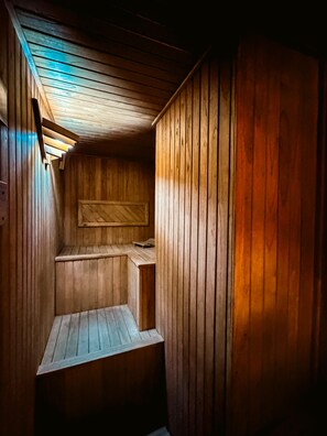 A wooden interior with a sloped ceiling and a built-in bench. - Hotel Los Silos (Santa Fe)