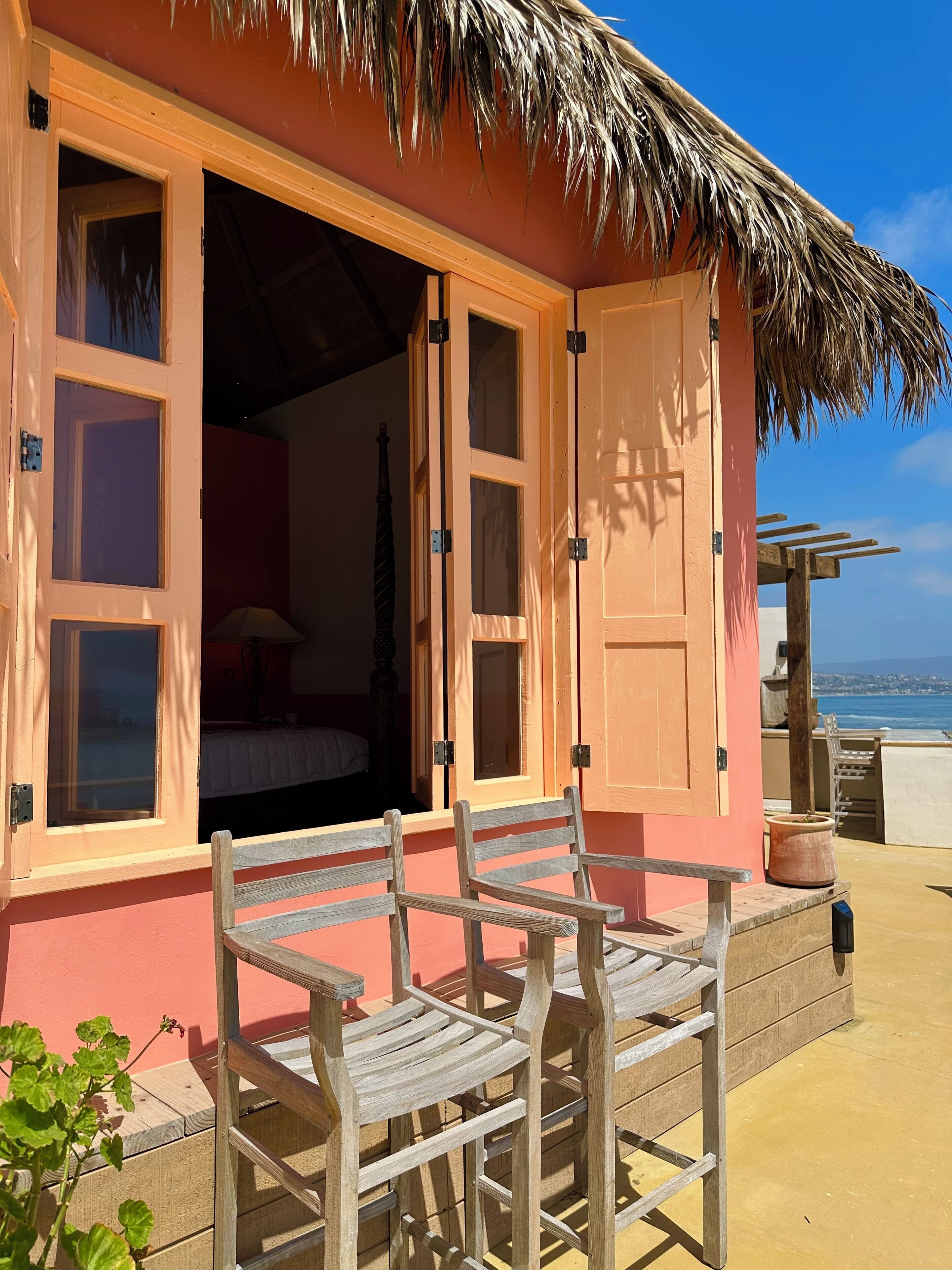 A cozy room with a bed, a window, and a view of the sea.