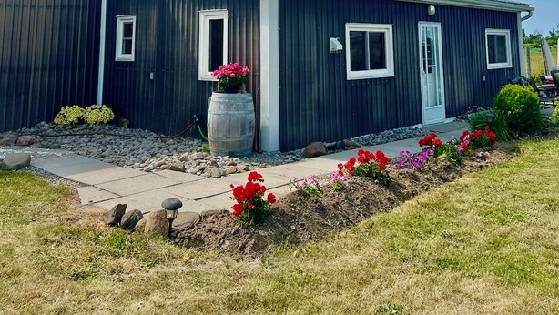 A modern two-story building with a dark exterior, a front door, and windows. - Stay at Jordan Valley Vineyards Barnhouse (Jordan Station)