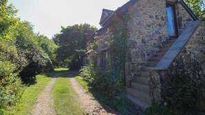 Un bâtiment en pierre avec un escalier menant à une porte.