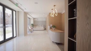 A modern interior with a kitchen area, a dining space, and a living room. - Modern Seaside Retreat · Stunning Sea View (Constanța)