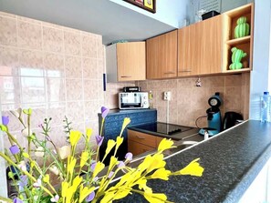 Microwave, stovetop, coffee/tea maker, cookware/dishes/utensils