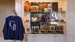 A display of coffee products and a CB sweatshirt on a shelf. - The Courtyard - Grand King Room at Cannon Beach Hotel Collection! (Cannon Beach)