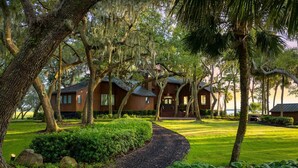A rustic cabin-style building surrounded by lush greenery and trees.