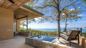 A modern outdoor area with a hot tub, seating, and a view of the ocean. - Villa Perla De Mar - Prime Ocean views and walking distance to beach! (Provincia de Puntarenas)
