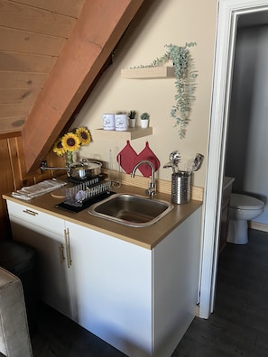 Fridge, microwave, coffee/tea maker, cookware/dishes/utensils