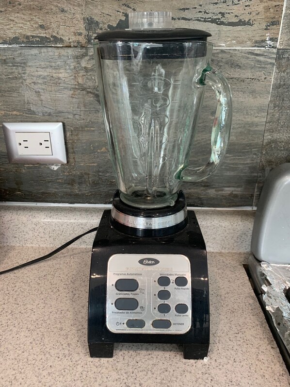 A kitchen with a blender on a countertop.