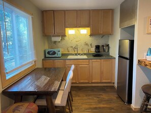 Fridge, microwave, coffee/tea maker, cookware/dishes/utensils