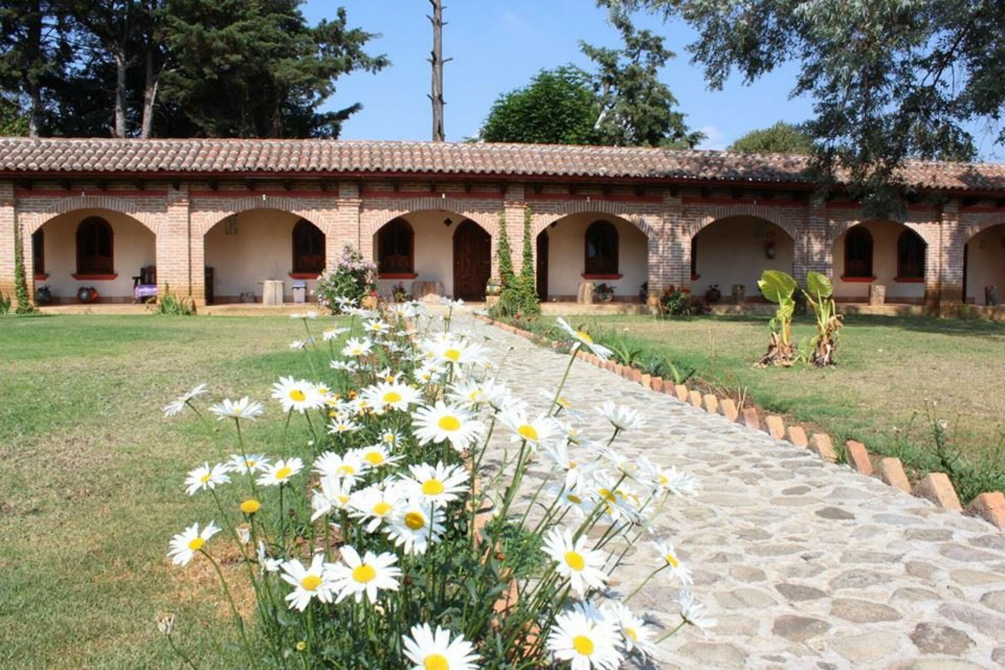 A building with a tiled roof and multiple arched windows.