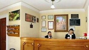 A reception desk with framed certificates and a wooden plaque. - Hotel Rincon Tarasco (Morelia)