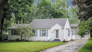 A single-story house with a front porch, a small front yard, and a driveway.