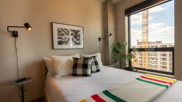 Laptop workspace, bed sheets