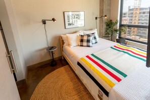 Apartment (0 Bedroom) | Laptop workspace, bed sheets