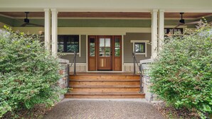 A house with a front porch, wooden steps, and a door with glass panels. - Turtle Lake Cottage (Shoreview)