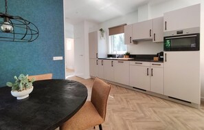 Fridge, stovetop, dishwasher, coffee/tea maker