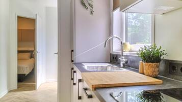 Fridge, stovetop, dishwasher, coffee/tea maker