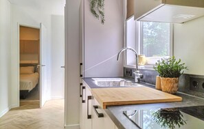 Fridge, stovetop, dishwasher, coffee/tea maker