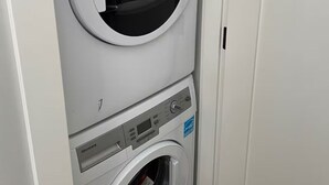 A front-loading washing machine with a control panel and a front-loading dryer.