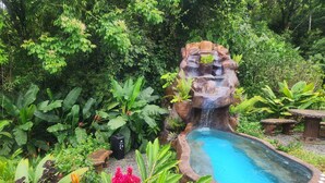 A garden with a water feature, including a waterfall and a pool. - Cabañas Caeli, El Colibri, NEW La Fortuna Rainforest Cabin w Panoramic Views (Peñas Blancas)