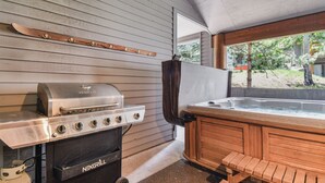 A NEXGRILL grill, a hot tub, and a ski rack against a wooden wall. - Deer Valley La Casa Boulder Creek (Park City)