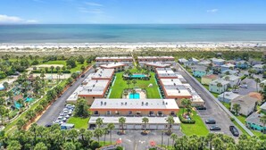 A hotel with a central pool, multiple buildings, and a beach view. - Private Beach Access, Steps from Ocean, Heated Pool, Garage, Beach towels/chairs (St. Augustine)