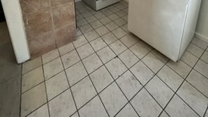 A compact kitchen with a gas stove, a built-in oven, a sink, and a white refrigerator. - Encore Inn Inglewood  (Inglewood)