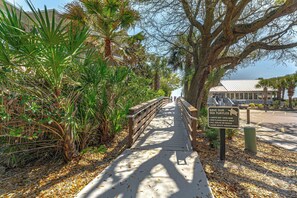 A wooden boardwalk with a sign about sea turtle conservation.
