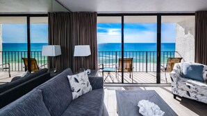 A balcony with a view of the ocean, furnished with a sofa, chairs, and a coffee table. - Luxe Gulf-front Free Beach Chairs Balcony View Resort Amenities ON THE Beach (Panama City Beach)