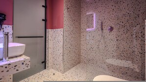 A modern bathroom with a glass shower enclosure, a white sink, and a small mirror. - Grandstay Studio 112 (Durrës)