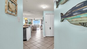 A spacious living area with a kitchen, dining area, and a view of the sea.