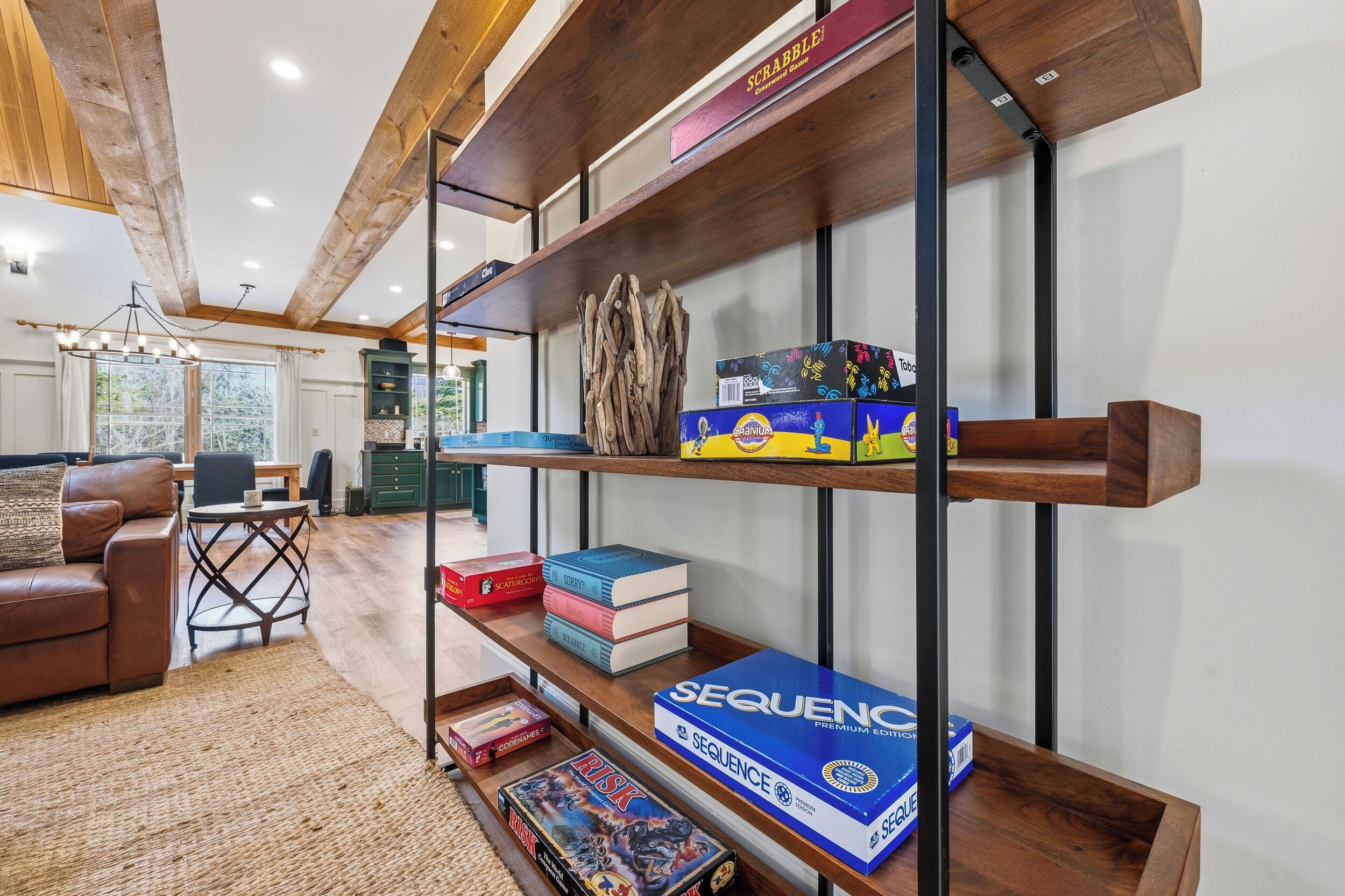 A living room with a wooden bookshelf, a leather sofa, and a coffee table.
