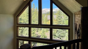 A room with large windows offering a view of mountains and trees. - Log Cabin w/ Billiards & Table Tennis - Mtn Views, 24mi Breck, Pet-Friendly (Fairplay)