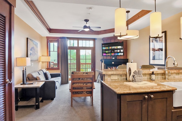 Spacious kitchen with modern appliances and breakfast bar seating.