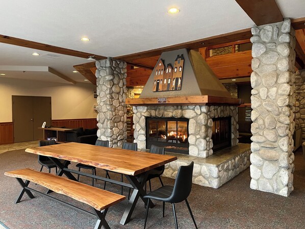 A stone fireplace with a wooden mantel and a built-in seating area.