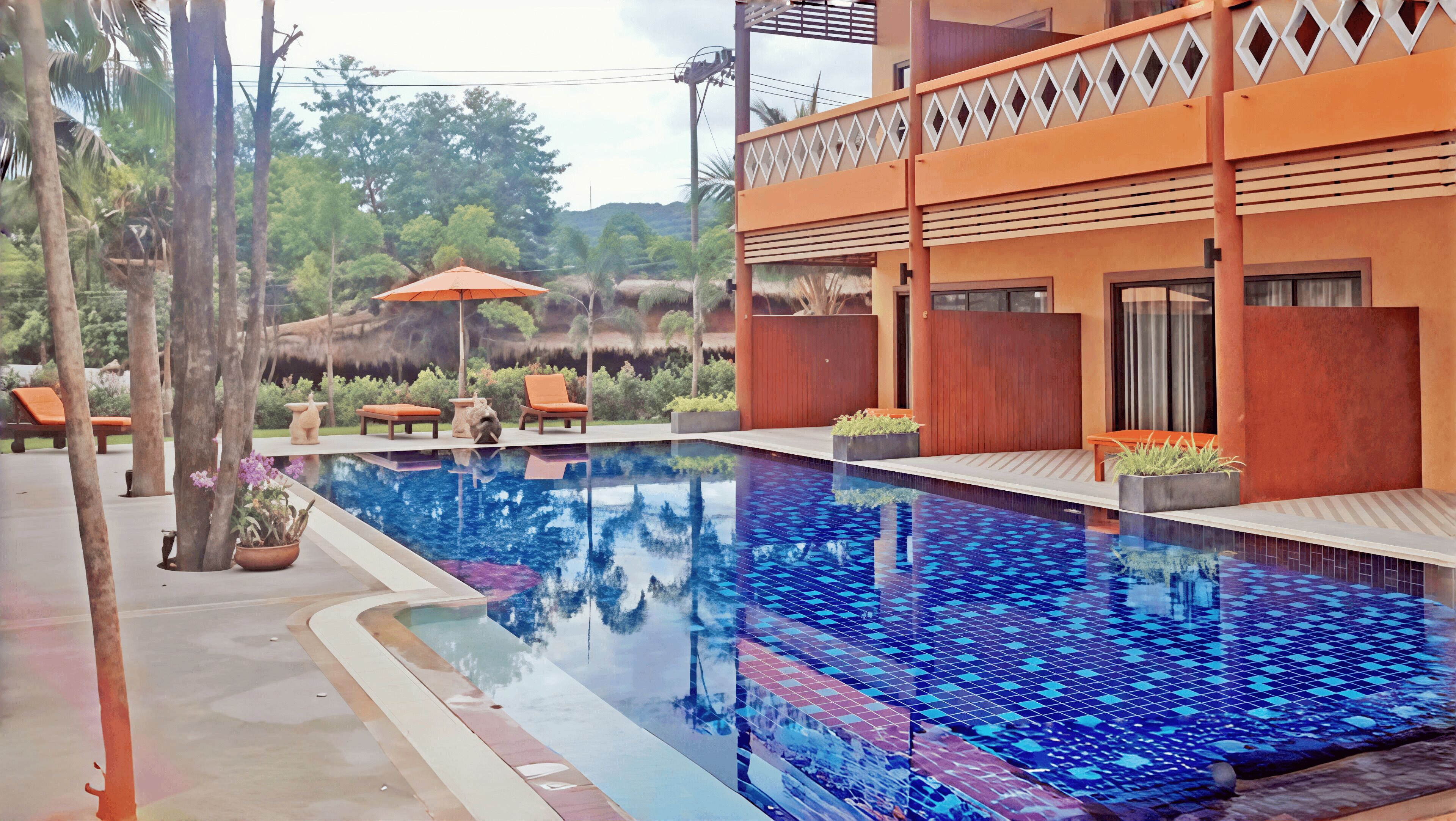 A swimming pool with a blue mosaic tile pattern, surrounded by lounge chairs and potted plants.