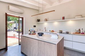 A modern kitchen with a central island, white cabinetry, and a built-in oven. - Villa Belvedere Condor - L, Alassio, Italy (Alassio)