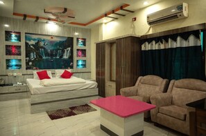 A modern bedroom with a bed, a desk, and a sofa. - Hotel Sahana & Restaurant - WB (Jangipur)