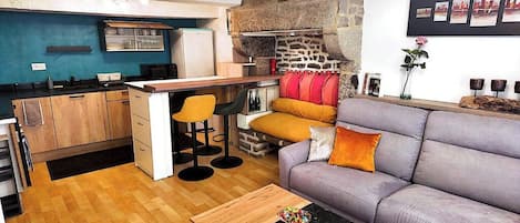 Ein kompakter Wohnbereich mit einer Küche, einem Sofa und einem Couchtisch.