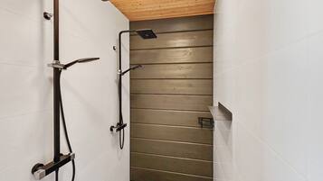 A narrow shower area with a wooden ceiling, white tiled walls, and a tiled floor.