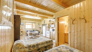 A cozy cabin with two beds, a kitchen, a dining area, and a living room. - Studio Cabin w/ Mtn Views by the Green River! (Cora)