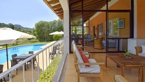 Un balcon avec une piscine, du mobilier d’extérieur et une vue sur le paysage.