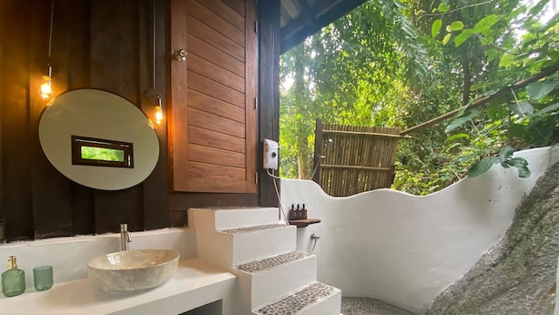 A bathroom with a stone sink, wooden cabinets, and a digital clock on the wall. - Tropical jungle escape just 5mins from Lamai beach (Chang Wat Surat Thani)