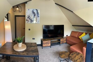Deluxe Apartment, Sea View | Living area | 45-inch Smart TV with digital channels