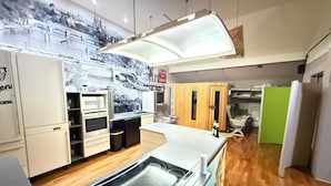 A modern kitchen with a built-in oven, microwave, and a large island with a sink. - Butterfly | swimming pool-sauna-whirlpool-billiard-air hockey-ping-pong-football-BBQ (Nievern)