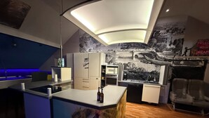 A modern kitchen with a central island, built-in appliances, and a mural on the wall. - Butterfly | swimming pool-sauna-whirlpool-billiard-air hockey-ping-pong-football-BBQ (Nievern)