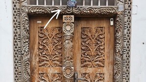 A wooden door with intricate carvings and a metal latch. - Hello Rafiki House - Stonetown (Zanzibar Town)