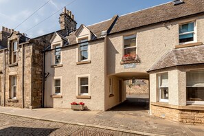 A traditional stone building with a sign reading "Kirkton Court." - Kidston Court (No 9) (St Andrews)