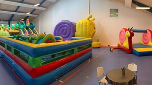 An indoor play area with inflatable structures, a table, and chairs. - 4 Person Holiday Home in Thyboron (Thyborøn)
