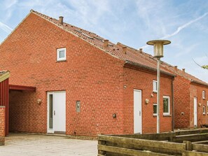 A red brick building with a pitched roof, a small window, and a door. - 4 Person Holiday Home in Thyboron (Thyborøn)
