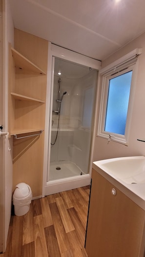 Shower, hair dryer, soap, toilet paper